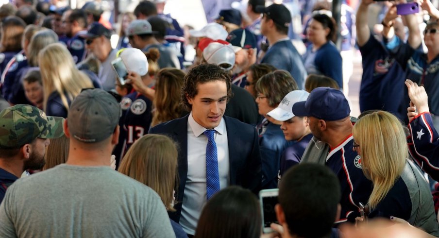 Columbus Blue Jackets left wing Sonny Milano (22) high fives fans while walking the Blue Carpet entrance prior to the game against the Carolina Hurricanes at Nationwide Arena.