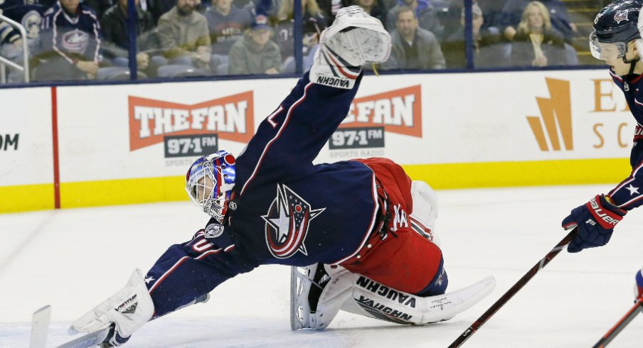 Columbus Blue Jackets goaltender Joonas Korpisalo attempts to stop the puck from entering the net against the Montreal Canadiens during a regular-season matchup at Nationwide Arena in January of 2019.