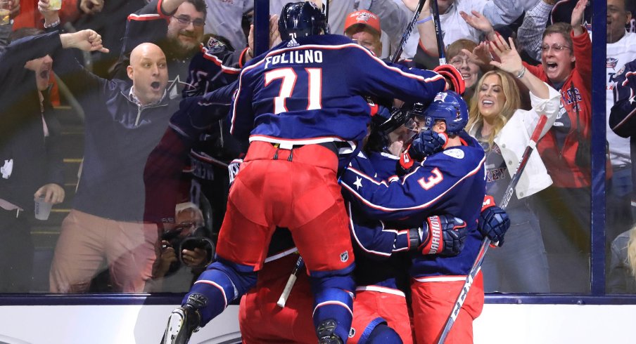 Columbus Blue Jackets forward Nick Foligno jumps onto his teammates to celebrate a goal scored against the Tampa Bay Lightning during the 2019 Stanley Cup Playoffs at Nationwide Arena.