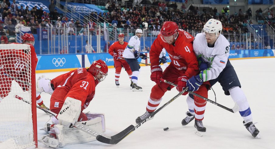 Feb 16, 2018; Gangneung, South Korea; Olympic Athlete of Russia defenseman Vladislav Gavrikov (4) and Slovenia forward Miha Verlic (91) battle for the puck in front of Olympic Athlete of Russia goalkeeper Ilya Sorokin (31) during the third period at the Pyeongchang 2018 Olympic Winter Games at Gangneung Hockey Centre.