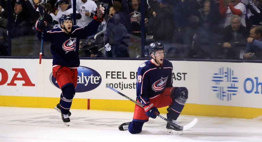 Apr 16, 2019; Columbus, OH, USA; Columbus Blue Jackets right wing Oliver Bjorkstrand (left) reacts to the goal scored by center Pierre-Luc Dubois (right) against the Tampa Bay Lightning in the first period during game four of the first round of the 2019 Stanley Cup Playoffs at Nationwide Arena. 