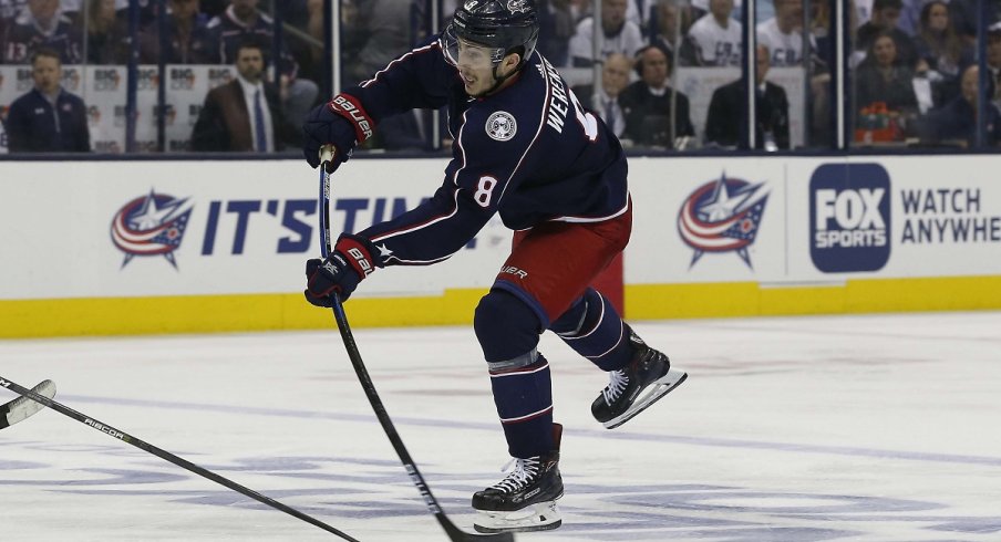 Zach Werenski snaps a puck against the Boston Bruins