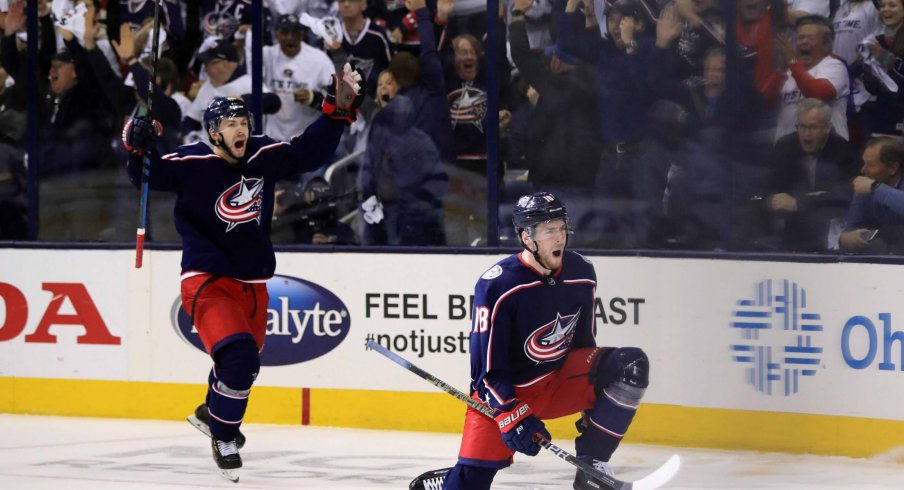 Apr 16, 2019; Columbus, OH, USA; Columbus Blue Jackets right wing Oliver Bjorkstrand (left) reacts to the goal scored by center Pierre-Luc Dubois (right) against the Tampa Bay Lightning in the first period during game four of the first round of the 2019 Stanley Cup Playoffs at Nationwide Arena. 