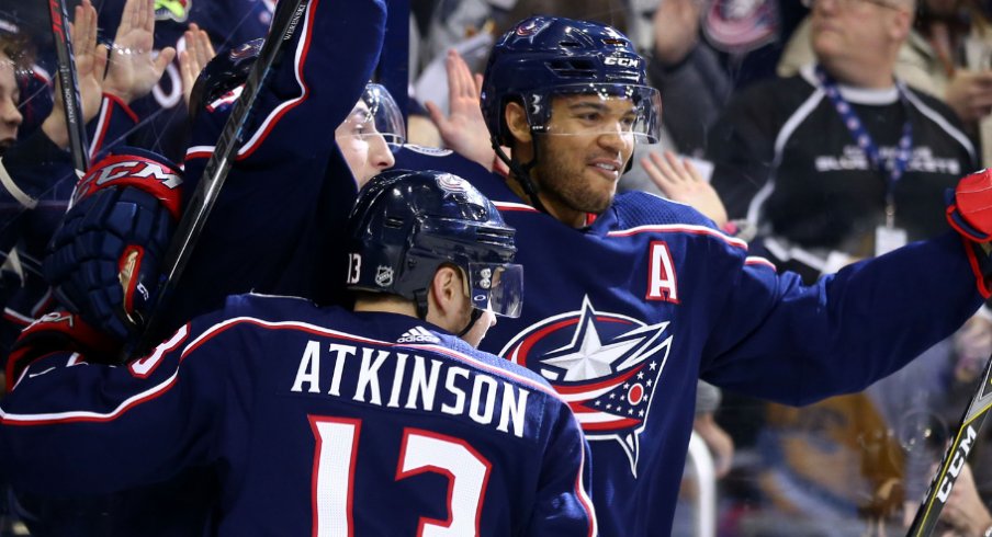 Columbus Blue Jackets forward Cam Atkinson celebrates alongside defensemen Zach Werenski and Seth Jones during a regular-season matchup with the Pittsburgh Penguins in April of 2018. 