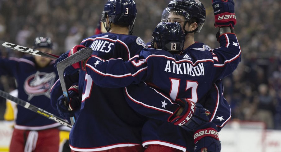 Seth Jones and Cam Atkinson celebrate a Blue Jackets goal scored against the Pittsburgh Penguins at Nationwide Arena.