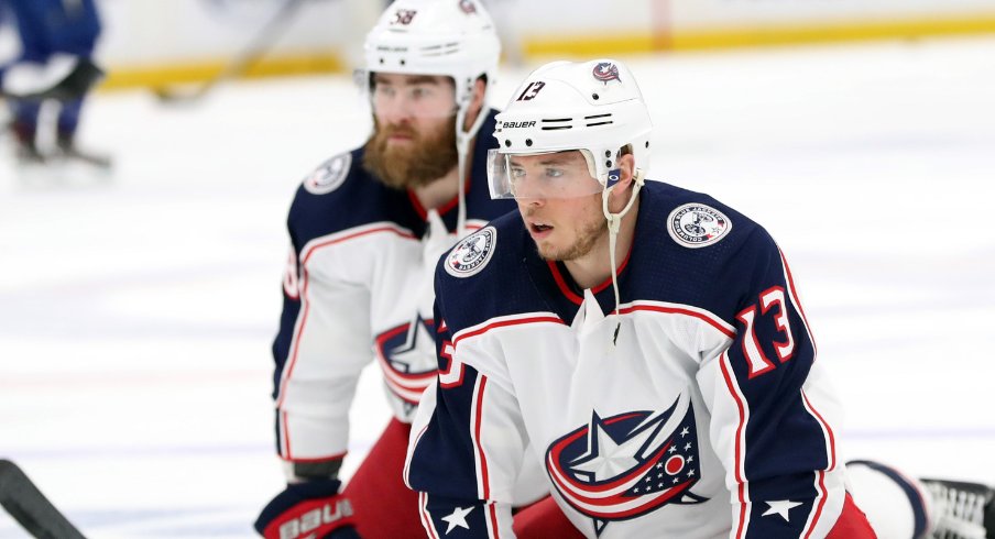 Columbus Blue Jackets defenseman David Savard and forward Cam Atkinson stretch on the ice prior to game two of the first round of the 2019 Stanley Cup Playoffs against the Tampa Bay Lightning at Amalie Arena.
