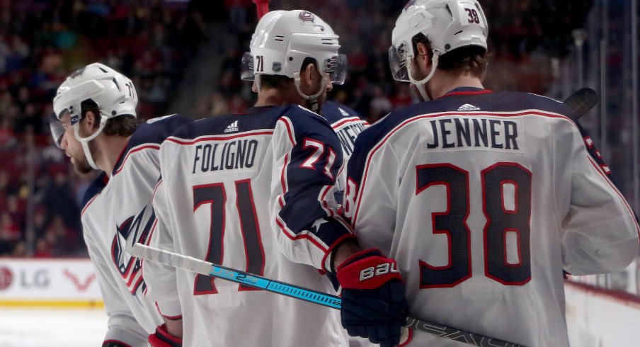 Columbus Blue Jackets forwards Nick Foligno, Boone Jenner and Josh Anderson celebrate a goal against the Montreal Canadiens at the Bell Centre in February of 2019.