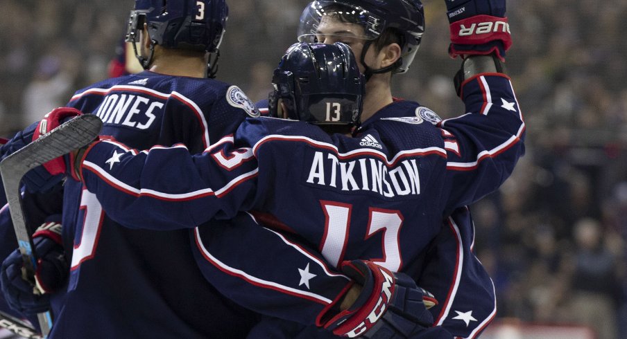 Columbus Blue Jackets forward Cam Atkinson celebrates an empty net goal with Seth Jones in a regular season contest against the Pittsburgh Penguins at Nationwide Arena during March of 2019. 