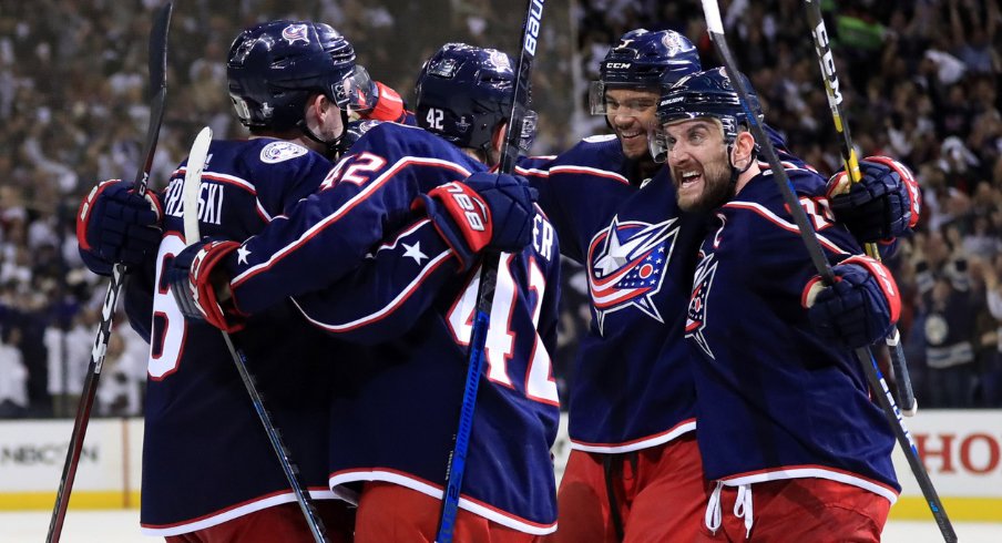 Columbus Blue Jackets defensemen Zach Werenski and Seth Jones celebrate with forwards Alexandre Texier and Nick Foligno during Game 4 of the first round of the 2019 Stanley Cup Playoffs at Nationwide Arena against the Tampa Bay Lightning.