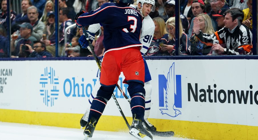 Columbus Blue Jackets defenseman skates toward John Tavares of the Toronto Maple Leafs during his team's home opener at Nationwide Arena.