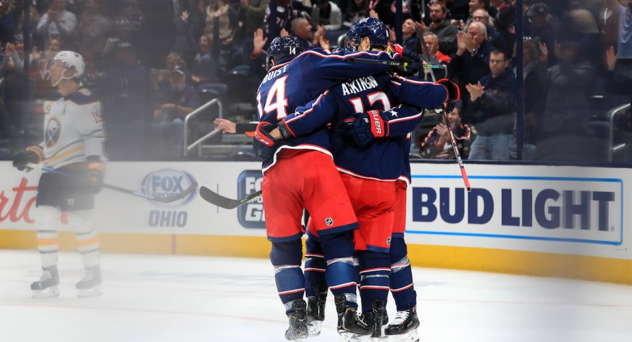 Columbus Blue Jackets right wing Cam Atkinson (13) celebrates with teammates after scoring a goal on a power play against the Buffalo Sabres in the first period at Nationwide Arena