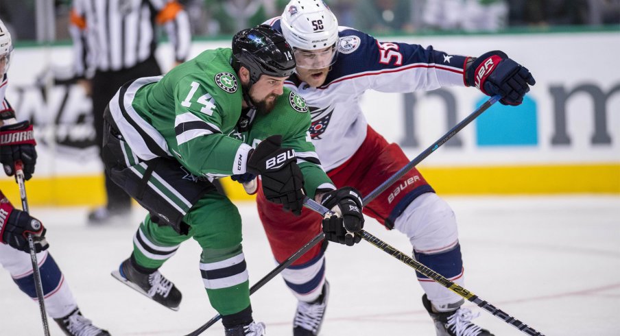 Dallas Stars left wing Jamie Benn (14) and Columbus Blue Jackets defenseman David Savard (58) chase the puck during the third period at the American Airlines Center.