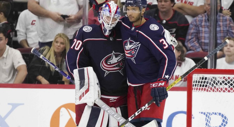 Joonas Korpisalo and Seth Jones celebrate after a 3-2 win over the Carolina Hurricanes on Saturday night.