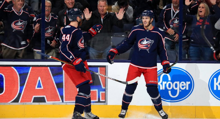 Oct 16, 2019; Columbus, OH, USA; Columbus Blue Jackets center Alexander Wennberg (10) celebrates with teammate defenseman Vladislav Gavrikov (44) after scoring a goal against the Dallas Stars in the first period at Nationwide Arena.