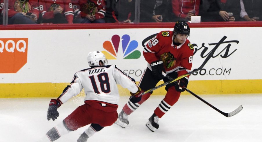 Chicago Blackhawks right wing Patrick Kane (88) is defended by Columbus Blue Jackets center Pierre-Luc Dubois (18) during the first period at United Center. 