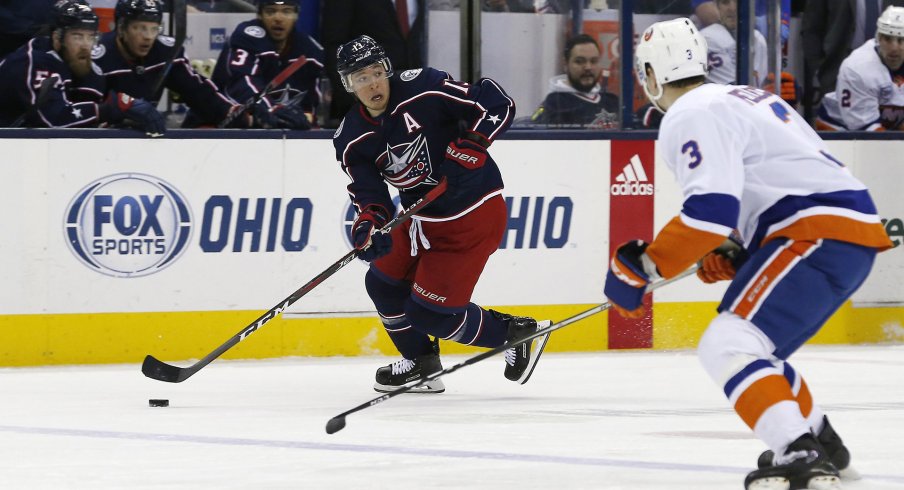 Mar 26, 2019; Columbus, OH, USA; Columbus Blue Jackets right wing Cam Atkinson (13) looks to pass as New York Islanders defenseman Adam Pelech (3) defends during the second period at Nationwide Arena.