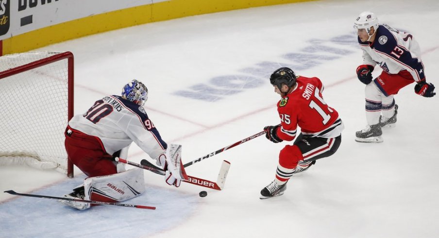 Oct 18, 2019; Chicago, IL, USA; Chicago Blackhawks center Zack Smith (15) tries to score against Columbus Blue Jackets goaltender Elvis Merzlikins (90) during third period at United Center. Mandatory Credit: Kamil Krzaczynski-USA TODAY Sports