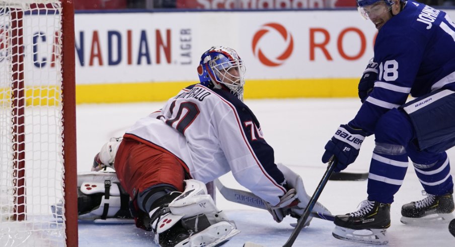 Columbus Blue Jackets goaltender Joonas Korpisalo spreads out to make a save against Andreas Johnsson of the Toronto Maple Leafs during a regular-season matchup during October of 2019.