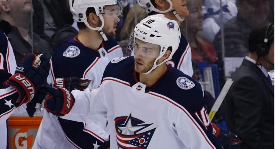Columbus Blue Jackets center Alexander Wennberg celebrates with his teammates after scoring the game-tying goal in a regular-season matchup against the Toronto Maple Leafs at Scotiabank Arena during October of 2019.