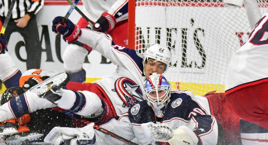 Oct 26, 2019; Philadelphia, PA, USA; Columbus Blue Jackets goaltender Joonas Korpisalo (70) and left wing Sonny Milano (22) keep the puck out of the net against the Philadelphia Flyers during the second period at Wells Fargo Center.