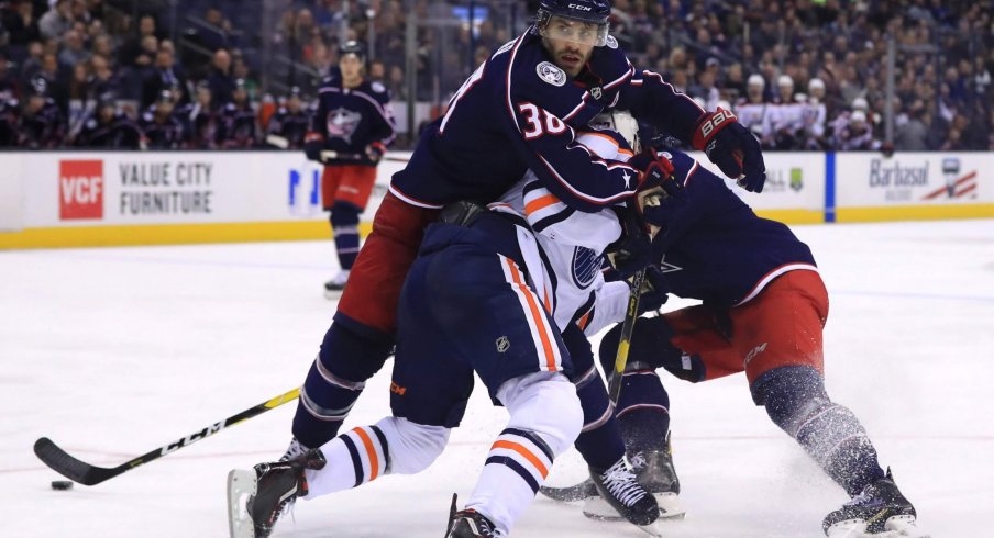 Mar 2, 2019; Columbus, OH, USA; Columbus Blue Jackets center Boone Jenner (38) is called for a holding penally against Edmonton Oilers center Connor McDavid (97) in the third at Nationwide Arena.