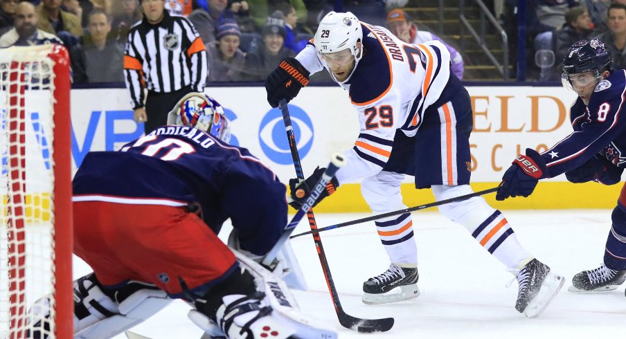 Columbus Blue Jackets goaltender Joonas Korpisalo is pictured preparing for a shot from Edmonton Oilers forward Leon Draisaitl in a regular-season matchup at Nationwide Arena in March of 2019.