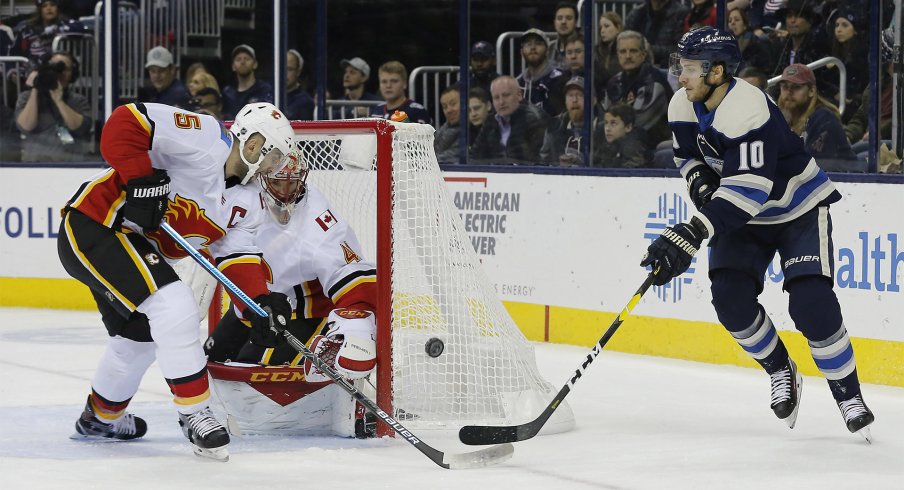 Calgary Flames defenseman Mark Giordano (5) knocks down the shot of Columbus Blue Jackets center Alexander Wennberg (10) during the second period at Nationwide Arena.