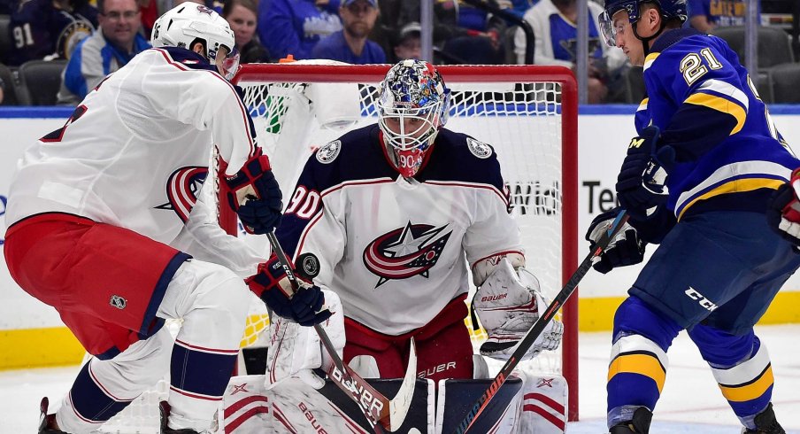 Sep 22, 2019; St. Louis, MO, USA; Columbus Blue Jackets goaltender Elvis Merzlikins (90) and defenseman Dean Kukan (46) defend against St. Louis Blues center Tyler Bozak (21) during the second period at Enterprise Center.