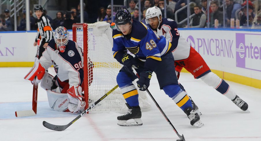 Nov 1, 2019; St. Louis, MO, USA; St. Louis Blues center Ivan Barbashev (49) skates with the puck as Columbus Blue Jackets defenseman Seth Jones (3) and goaltender Elvis Merzlikins (90) defend the net during the second period at Enterprise Center.