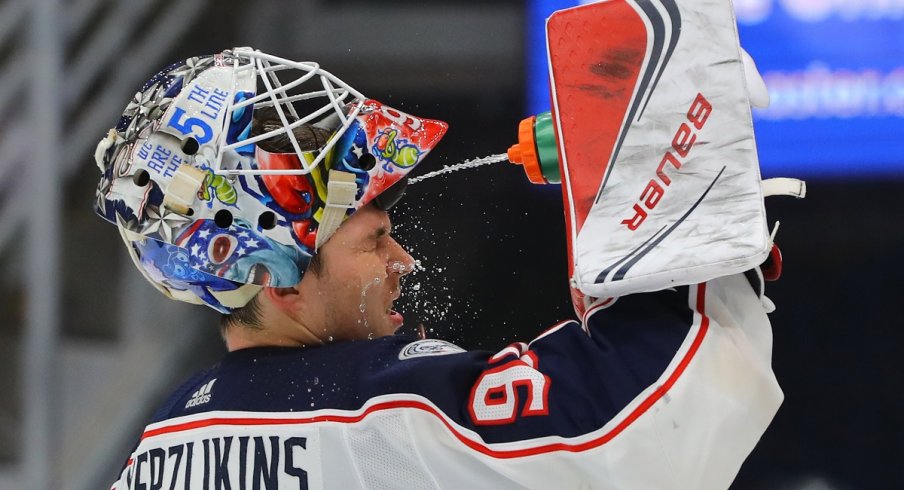 Elvis Merzlikins squirts water in his face during a stoppage against the St. Louis Blues