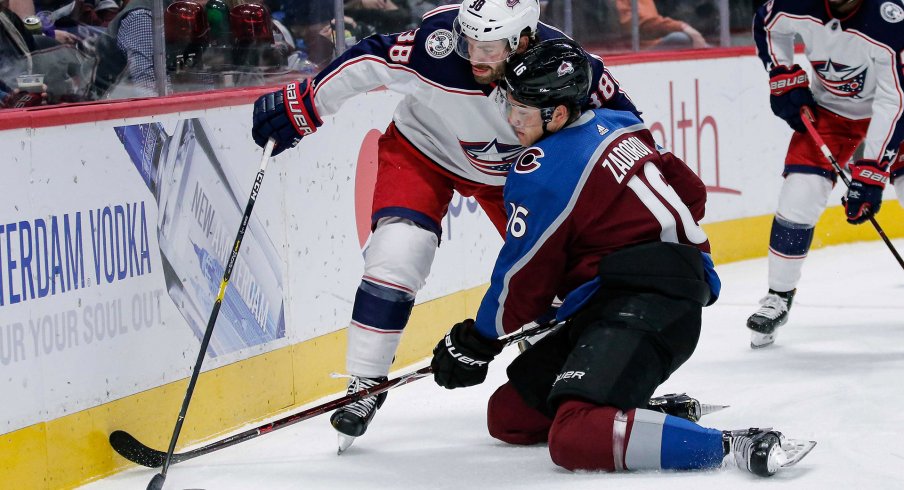 Feb 5, 2019; Denver, CO, USA; Columbus Blue Jackets center Boone Jenner (38) and Colorado Avalanche defenseman Nikita Zadorov (16) battle for the puck in the first period at the Pepsi Center.