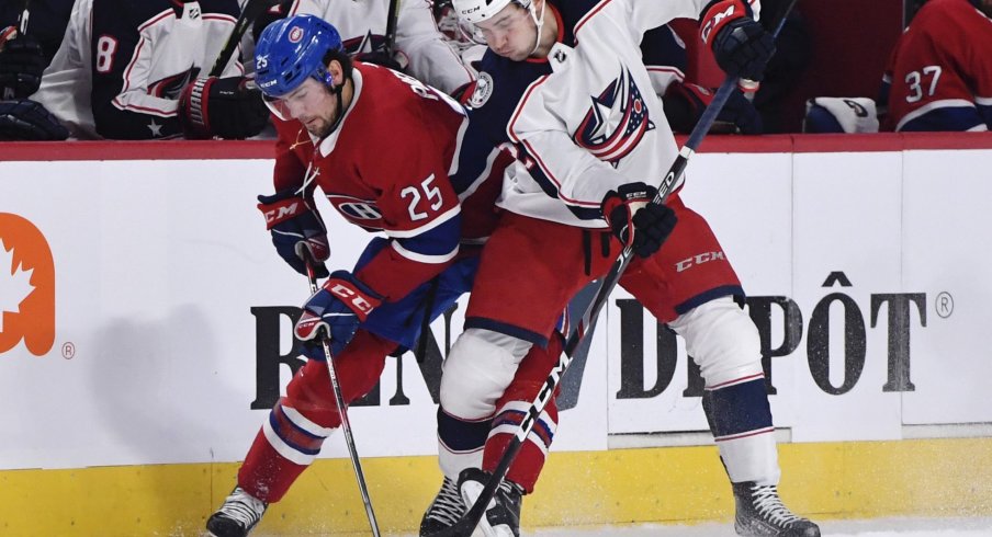 Nov 12, 2019; Montreal, Quebec, CAN; Montreal Canadiens forward Ryan Poehling (25) battles with Columbus Blue Jackets forward Emil Bemstrom (52) for possession of the puck during the second period at the Bell Centre.