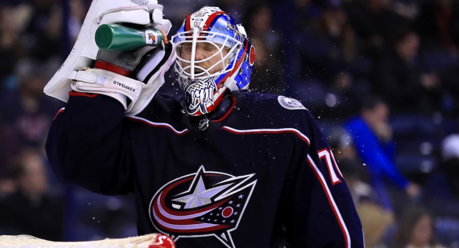 Columbus Blue Jackets goaltender Joonas Korpisalo hydrates during a stoppage in play at Nationwide Arena.