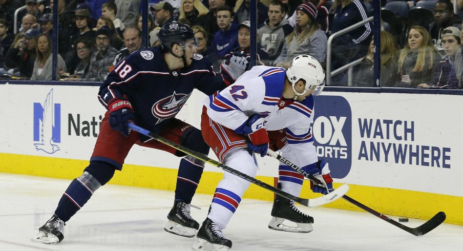 Jan 13, 2019; Columbus, OH, USA; Columbus Blue Jackets left wing Pierre-Luc Dubois (18) and New York Rangers defenseman Brendan Smith (42) battle the puck during the second period at Nationwide Arena. Mandatory Credit: Russell LaBounty-USA TODAY Sports