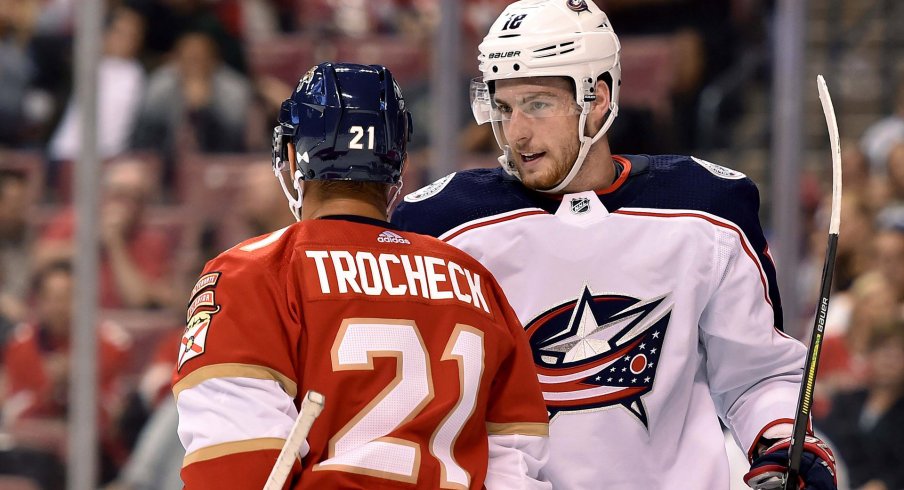 Oct 11, 2018; Sunrise, FL, USA; Columbus Blue Jackets center Pierre-Luc Dubois (18) exchange words with Florida Panthers center Vincent Trocheck (21) during the first period at BB&T Center. 