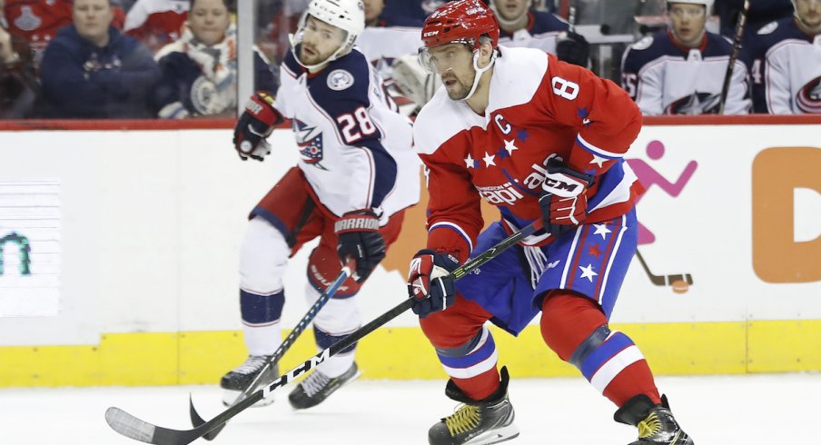 Columbus Blue Jackets forward Oliver Bjorkstrand fights for the puck against Alexander Ovechkin of the Washington Capitals.