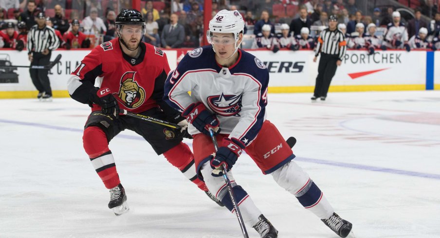 Apr 6, 2019; Ottawa, Ontario, CAN; Columbus Blue Jackets center Alexandre Texier (42) skates wit hthe puck in front of Ottawa Senators center Chris Tierney (71) in the first period at the Canadian Tire Centre.