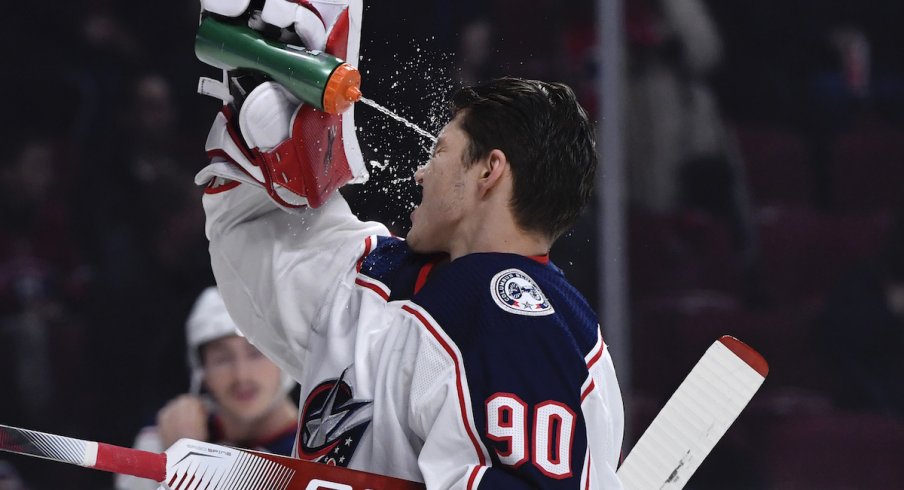 Columbus Blue Jackets goalie Elvis Merzlikins (90) splashes some water on his face during the first period of the game against the Montreal Canadiens at the Bell Centre.