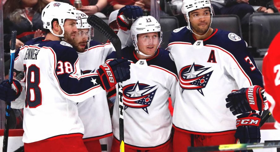 Columbus Blue Jackets right wing Oliver Bjorkstrand (28) receives congratulations from teammates after scoring in the first period against the Detroit Red Wings at Little Caesars Arena.