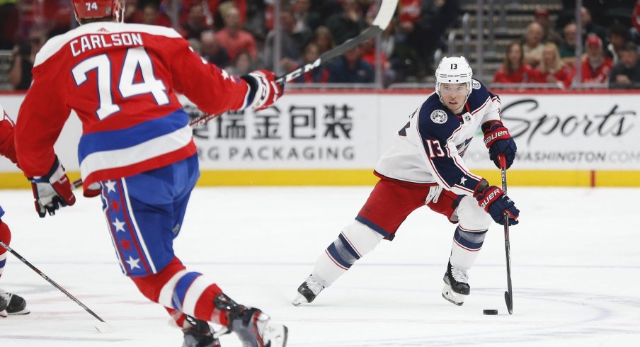 Dec 9, 2019; Washington, DC, USA; Columbus Blue Jackets right wing Cam Atkinson (13) skates with the puck as Washington Capitals defenseman John Carlson (74) defends in the first period at Capital One Arena.
