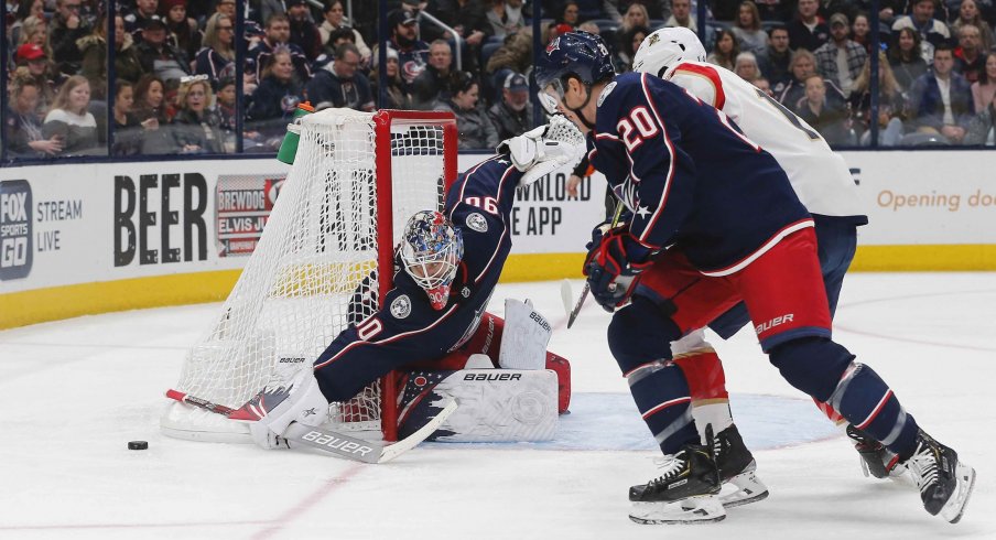 Dec 31, 2019; Columbus, Ohio, USA; Columbus Blue Jackets goalie Elvis Merzlikins (90) makes a sticks save against the Florida Panthers during the first period at Nationwide Arena.