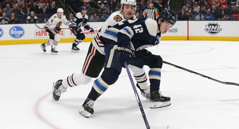 Dennis Gilbert attempts to steal the puck from Alexandre Texier 