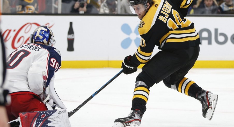 Jan 2, 2020; Boston, Massachusetts, USA; Columbus Blue Jackets goaltender Elvis Merzlikins (90) stops a shot by Boston Bruins left wing Anders Bjork (10) during the third period at TD Garden.