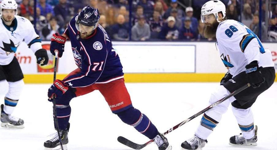 Feb 23, 2019; Columbus, OH, USA; Columbus Blue Jackets left wing Nick Foligno (71) shoots the puck as San Jose Sharks defenseman Brent Burns (88) defends at Nationwide Arena.