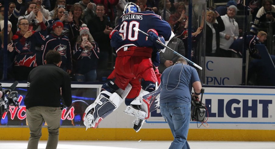 Columbus Blue Jackets goalie Elvis Merzlikins (90) and left wing Nick Foligno (71) celebrate the win after the game against the Florida Panthers at Nationwide Arena.