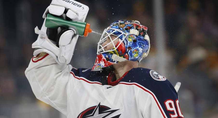 Jan 2, 2020; Boston, Massachusetts, USA; Columbus Blue Jackets goaltender Elvis Merzlikins (90) sprays water on his face during the third period against the Boston Bruins at TD Garden. Mandatory Credit: Greg M. Cooper-USA TODAY Sports