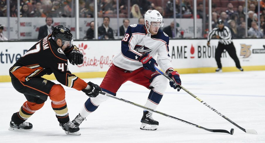 Columbus Blue Jackets center Pierre-Luc Dubois (18) handles the puck while under pressure by Anaheim Ducks defenseman Hampus Lindholm (47) during the second period at Honda Center.