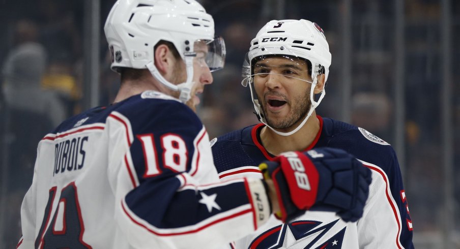 Pierre-Luc Dubois and Seth Jones celebrate an overtime-winning goal against the Boston Bruins.