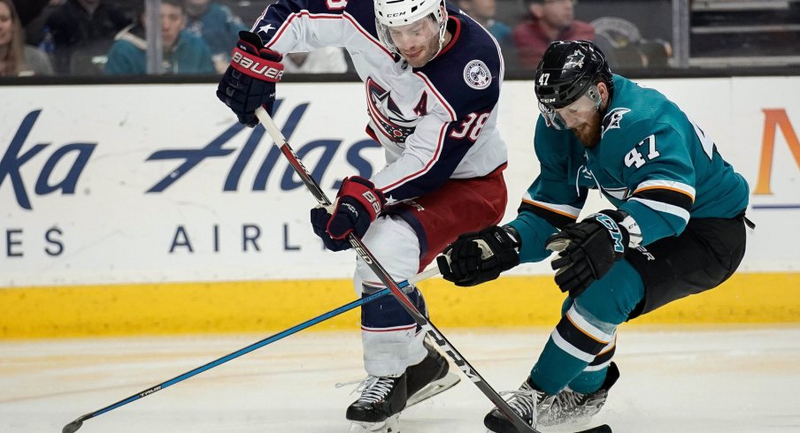 Mar 4, 2018; San Jose, CA, USA; Columbus Blue Jackets center Boone Jenner (38) and San Jose Sharks defenseman Joakim Ryan (47) fight for control of the puck during the third period at SAP Center at San Jose. Mandatory Credit: Stan Szeto-USA TODAY Sports