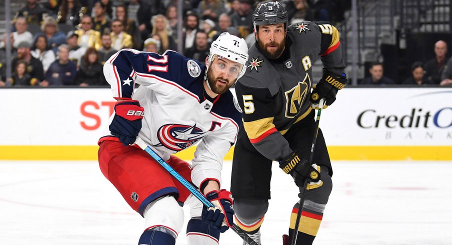 Feb 9, 2019; Las Vegas, NV, USA; Vegas Golden Knights defenseman Deryk Engelland (5) covers Columbus Blue Jackets left wing Nick Foligno (71) during the third period at T-Mobile Arena.